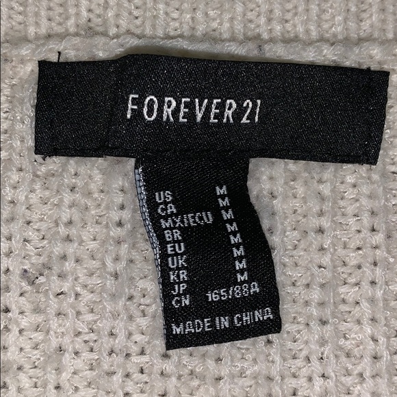 A white knitted sweater. - Picture 2 of 2